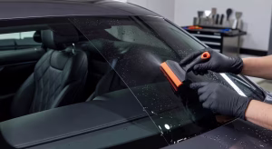 Proceso profesional de instalación de lámina de tintado en luna trasera de coche de lujo