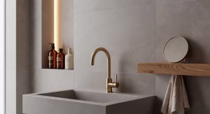 Detalle de grifería de latón cepillado y porcelánico de gran formato en baño de diseño